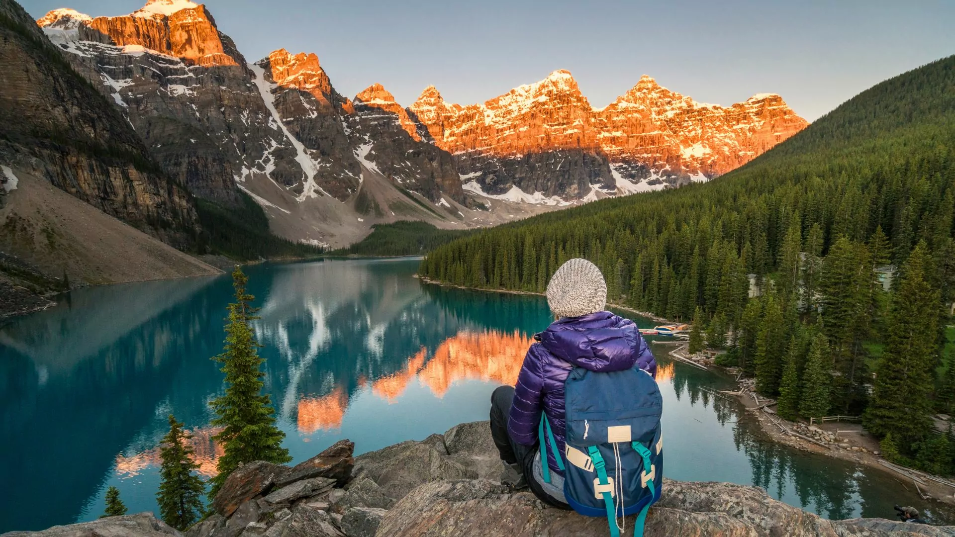 A hiker sits overlooking a lake in Banff National Park